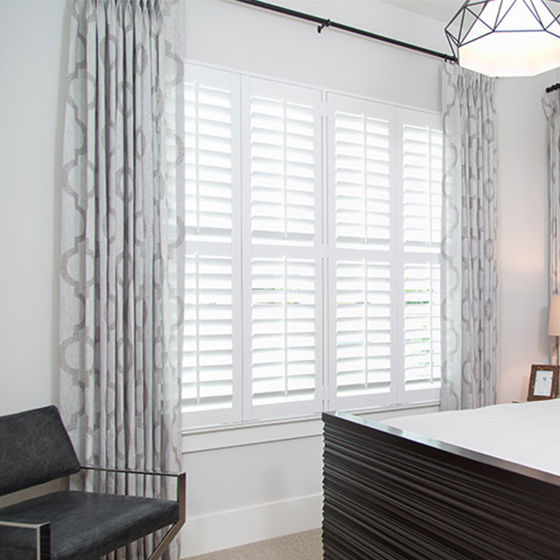 Plantation white shutters in a large bedroom