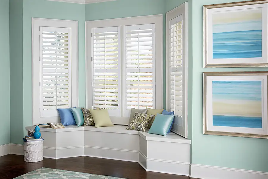 If your window looks like this, you have a bay window, not to be confused with a bow window. White Polywood Shutters on a bay window seat area