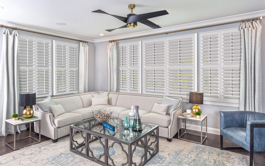 White split tilt shutters in a living room.