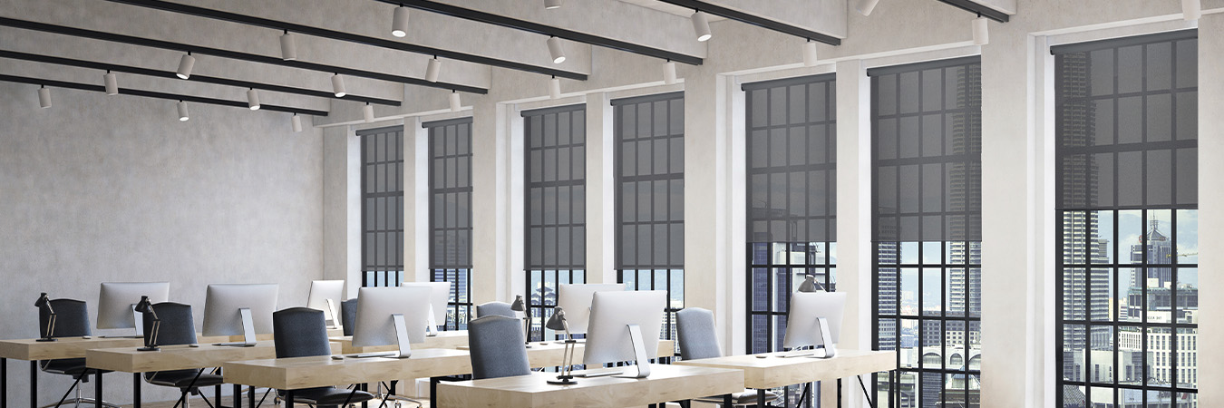 Gray window shades on windows in a modern office setting