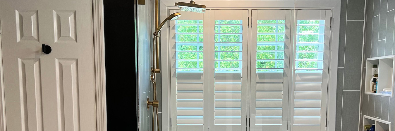 Polywood shutters with split tilt rods on a shower window