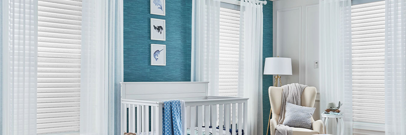 White polywood shutters in three windows of a baby room 