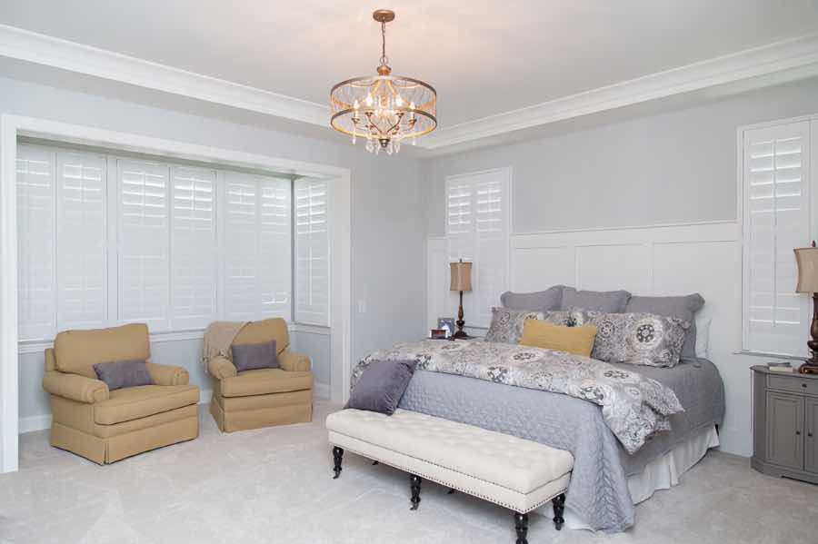 Closed Polywood shutters on three living room windows