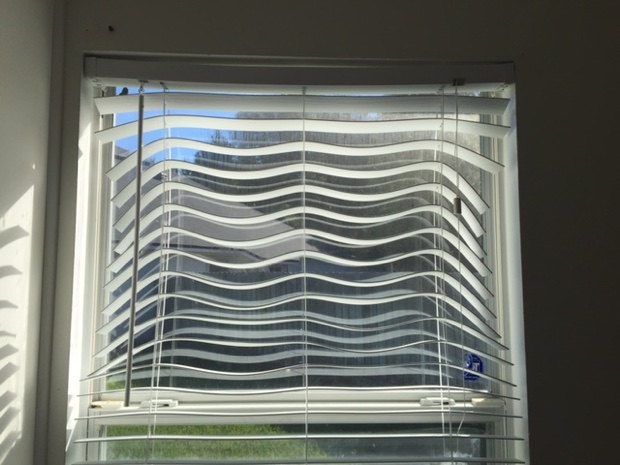 Warped blinds in a window