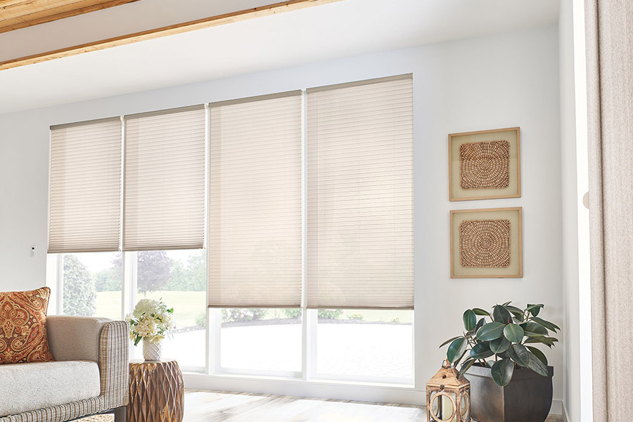 Beige cellular shades on tall living room windows