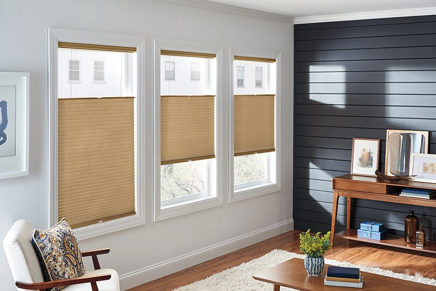 If your windows open two different ways, choose versatile window treatments that do too! Tan top-down/bottom-up cellular shades on living room windows