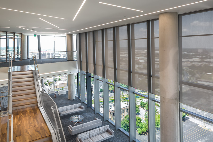 Gray shades on very tall lobby windows