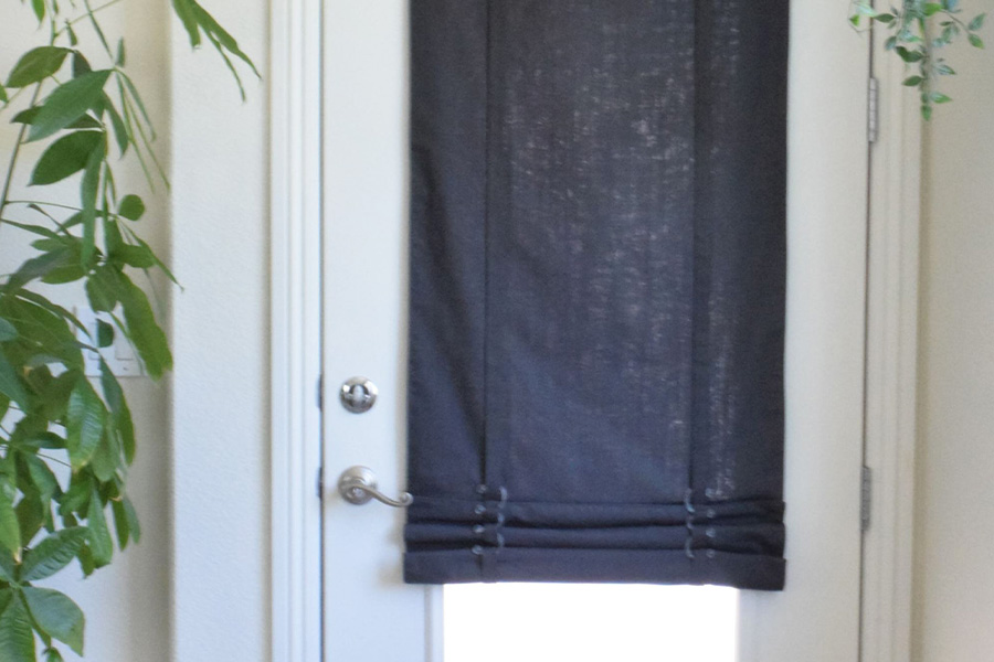 Dark gray tumble shade on a white back door