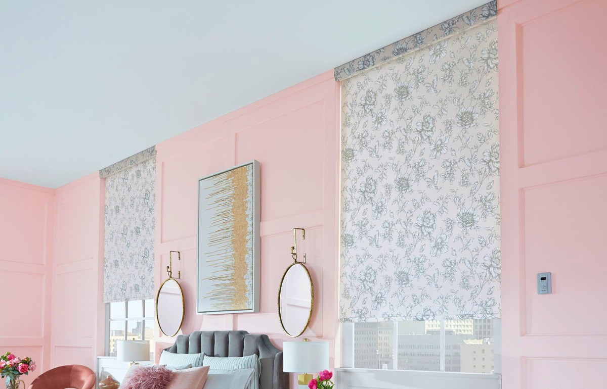 Gray floral window shades on windows in a pink bedroom