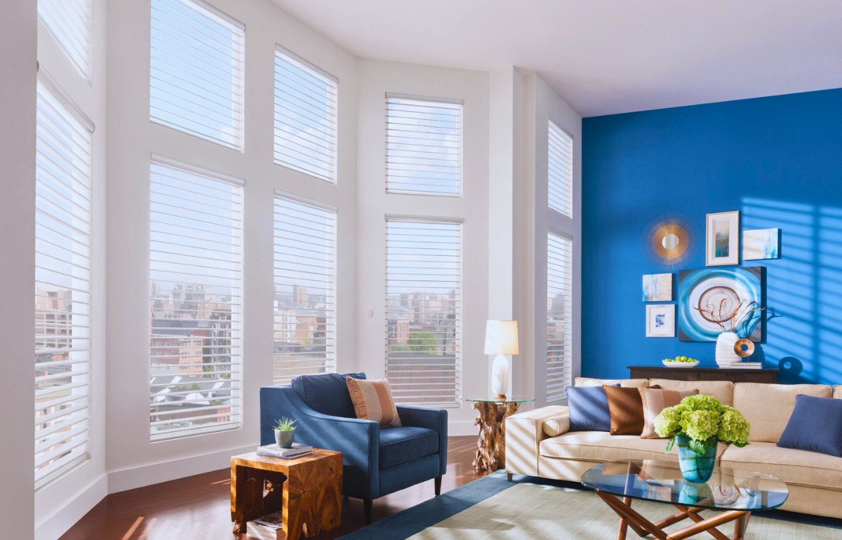 White sheer shades on tall living room windows