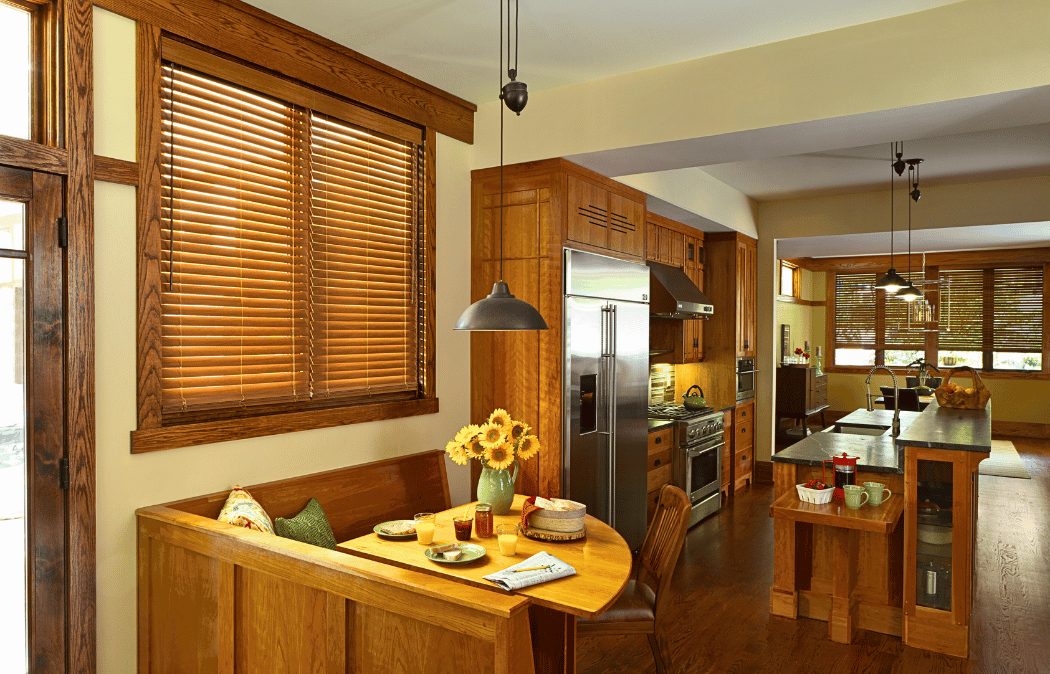 Faux wood window blinds matching the wood cabinets of a kitchen