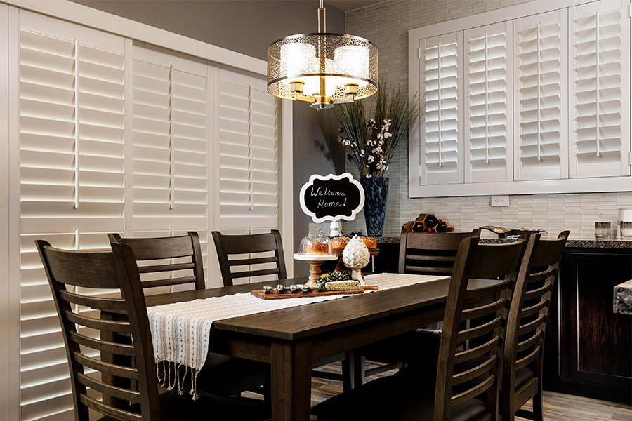 White Polywood shutters on a sliding door in a stylish dining room