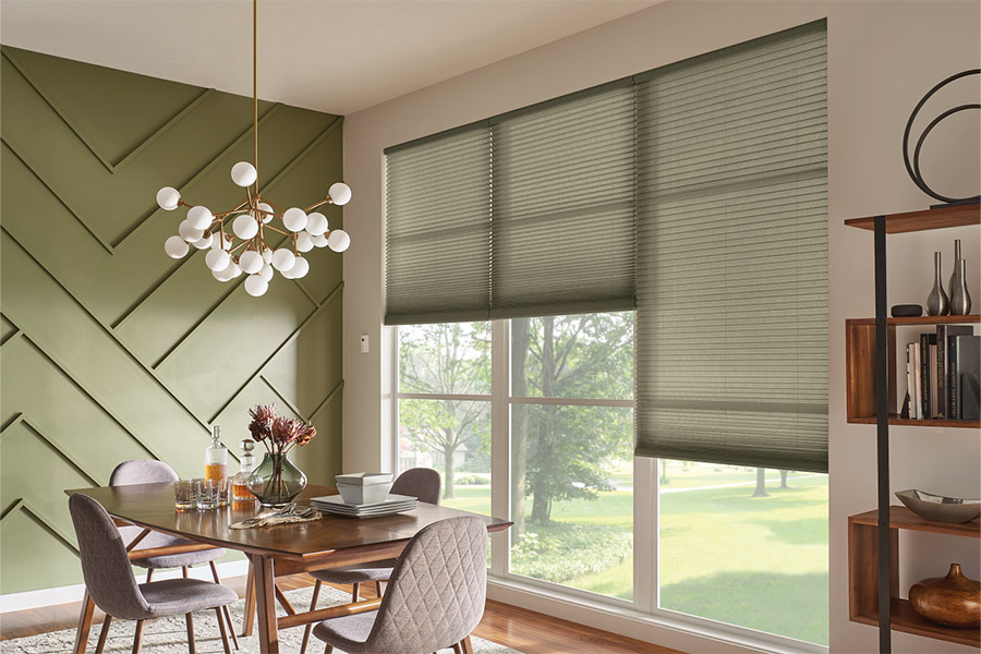 Green cellular shades in a green dining room