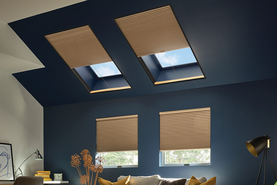  Tan cellular shades on windows and skylights in a blue living room