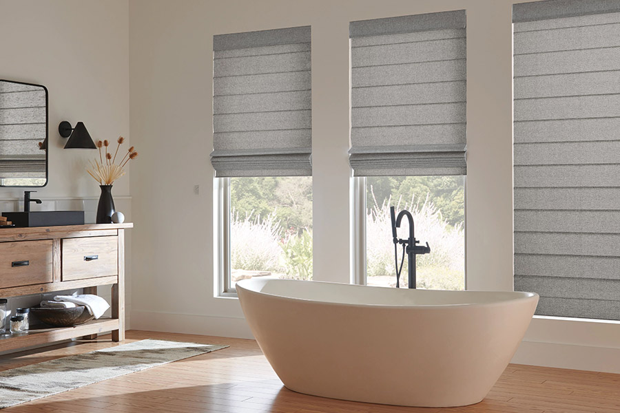 Gray Roman shades on bathroom windows