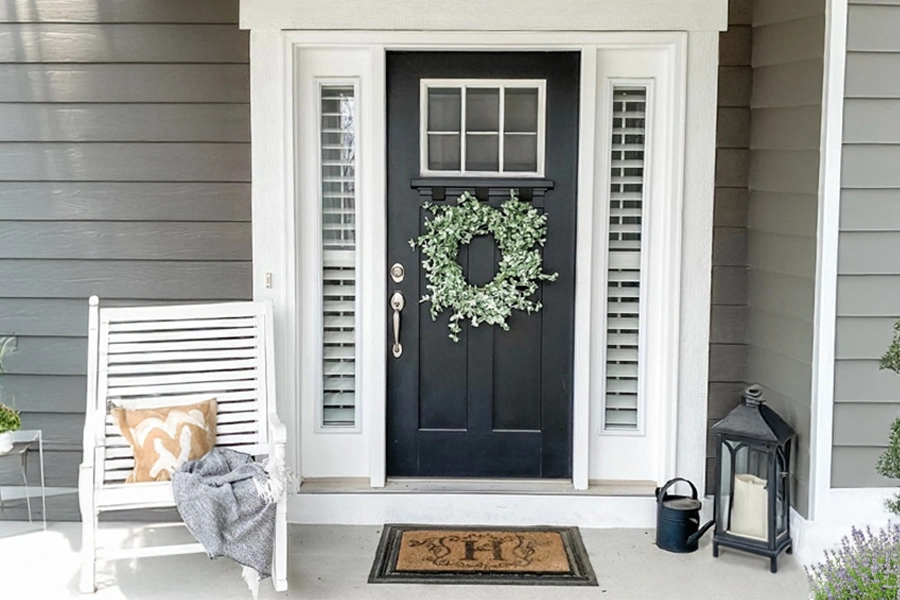 Wide sidelight windows need window treatments you can open easily to peek outside. White sidelight shutters displayed on a front porch