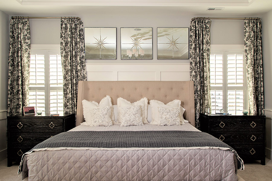 White interior shutters with divider rails on bedroom windows