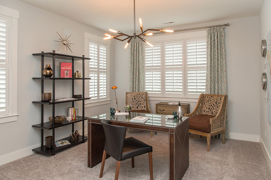 Split tilt rods on white interior shutters on home office windows