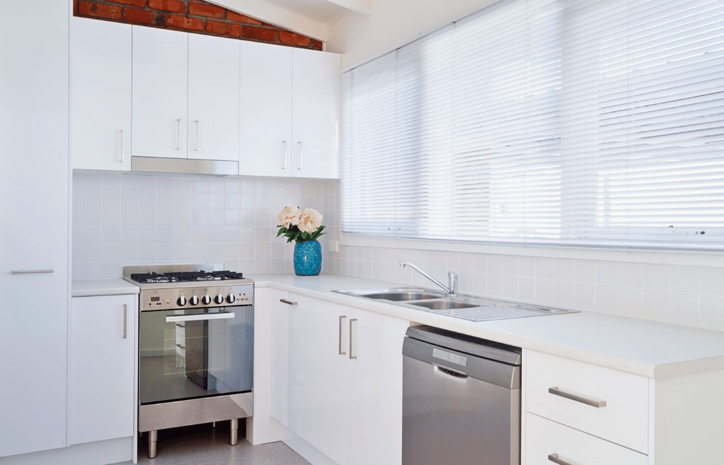 White faux blinds in a bright modern kitchen