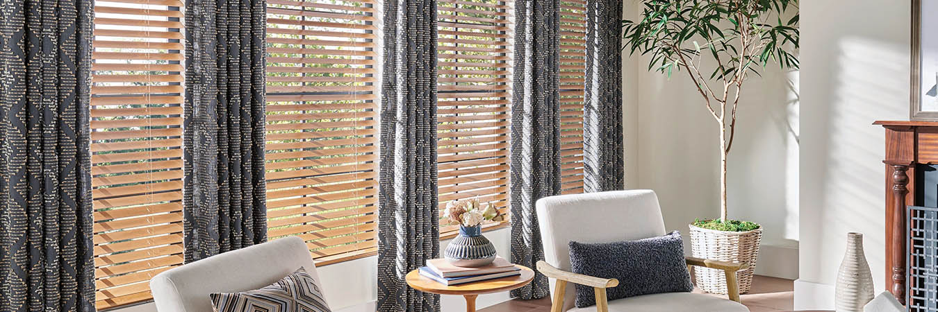 wooden blinds with draperies in a living room