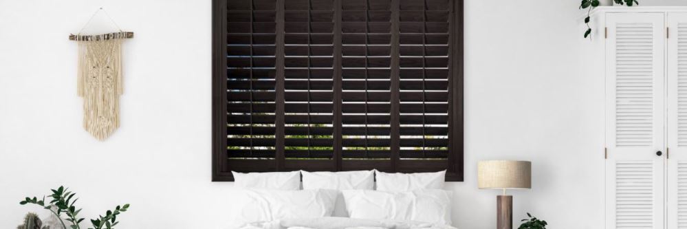 Wood shutters in bedroom in