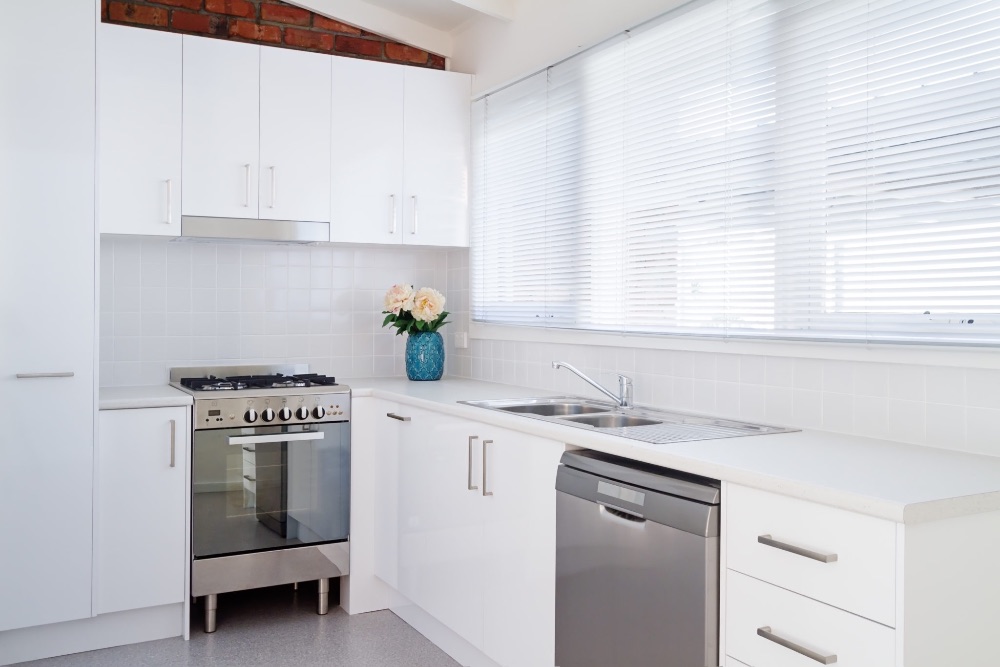 Faux wood blinds in airy kitchen