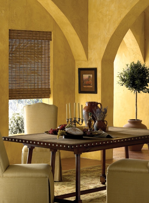 Woven shades in an arched dining room