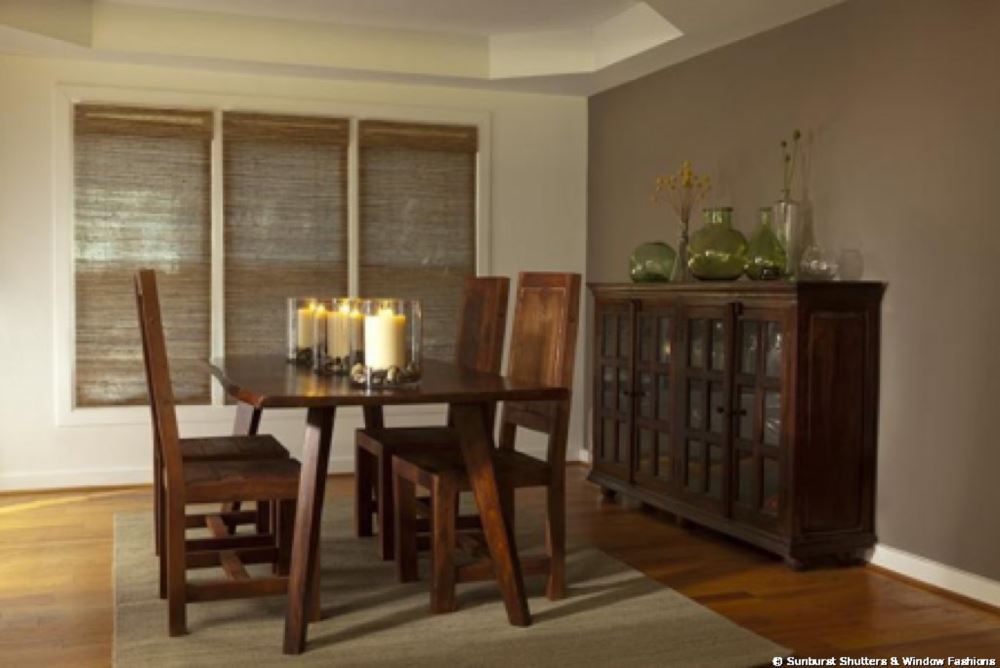 Woven shades in a dining room with candles