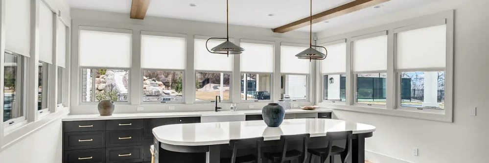 White window shades on kitchen windows in an empty, modern kitchen