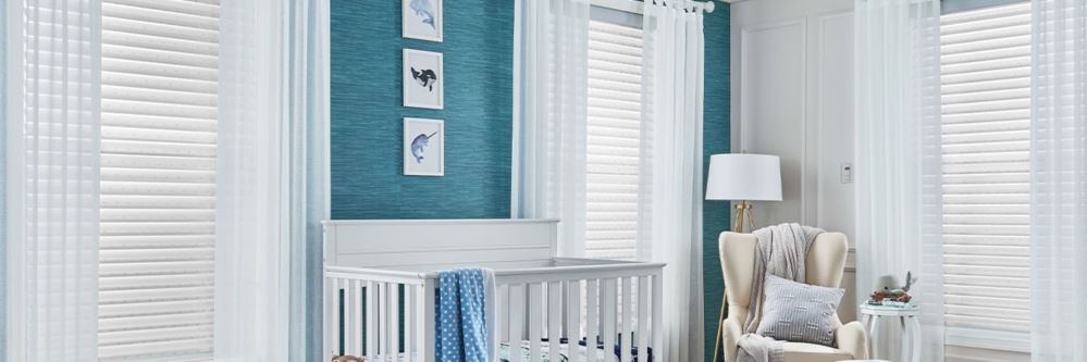 White polywood shutters in three windows of a baby room