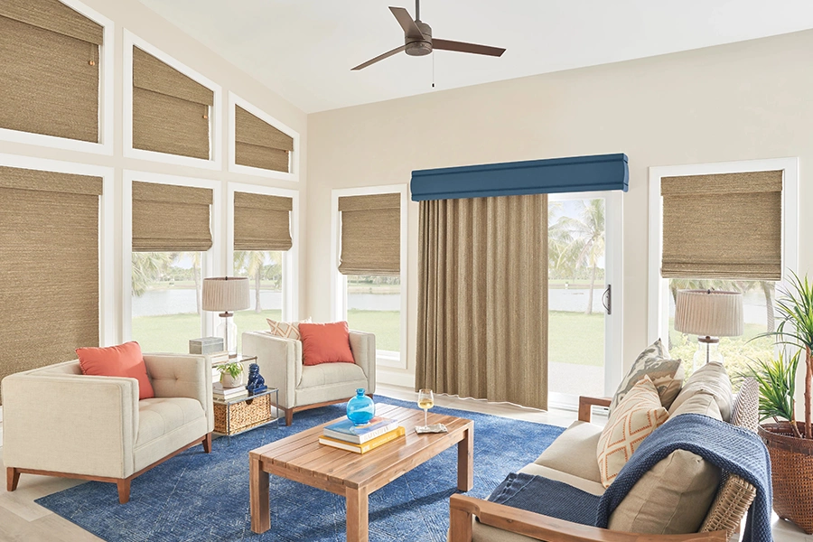 Window shades make it easy to continue your room's color palette. Tan shades on rake windows in mid-century living room
