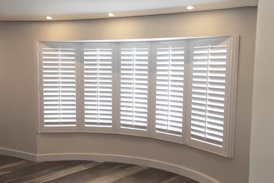 With so many windows in a row, keep your home protected from outside temperatures with insulating Polywood shutters on your bow windows. With so many windows in a row, keep your home protected from outside temperatures with insulating Polywood shutters on your bow windows.