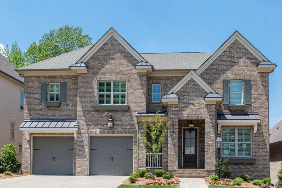 Enhance your curb appeal by using matching window treatments on all of your windows. The exterior of a home with white Polywood shutters in each window