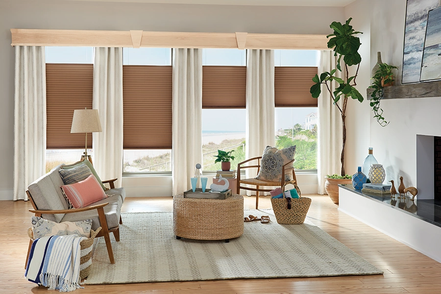 Add elegance to the mid-century modern look with coordinated fabric window treatments. Cream drapes with brown shades on tall living room windows