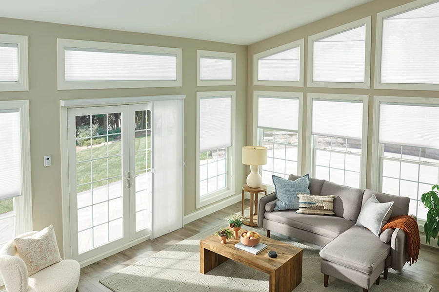 Pick your preferred color, material, and opacity to customize the perfect window shades for your rake window. White cellular shades on a rake window in a beige living room
