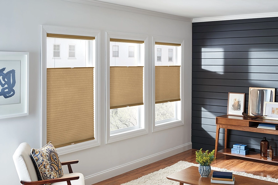 Tan brown cellular shades in an office with an urban city view