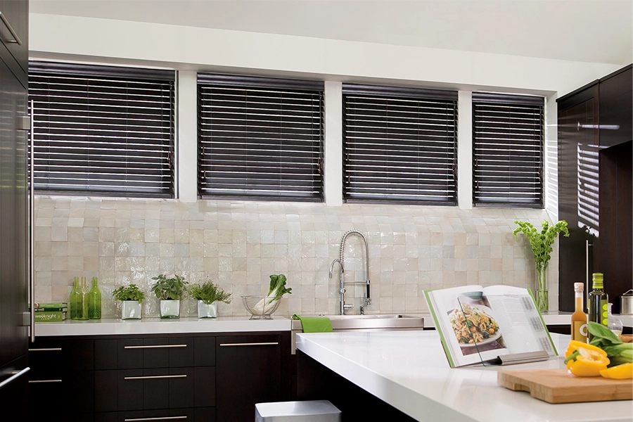 If you want window blinds, only get top-quality wood or faux wood blinds that last longer than cheaply made products. Dark wood blinds on kitchen windows