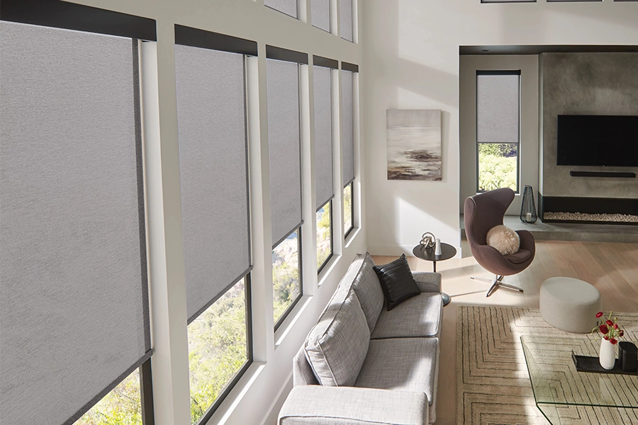 Gray solar shades on rows of living room windows