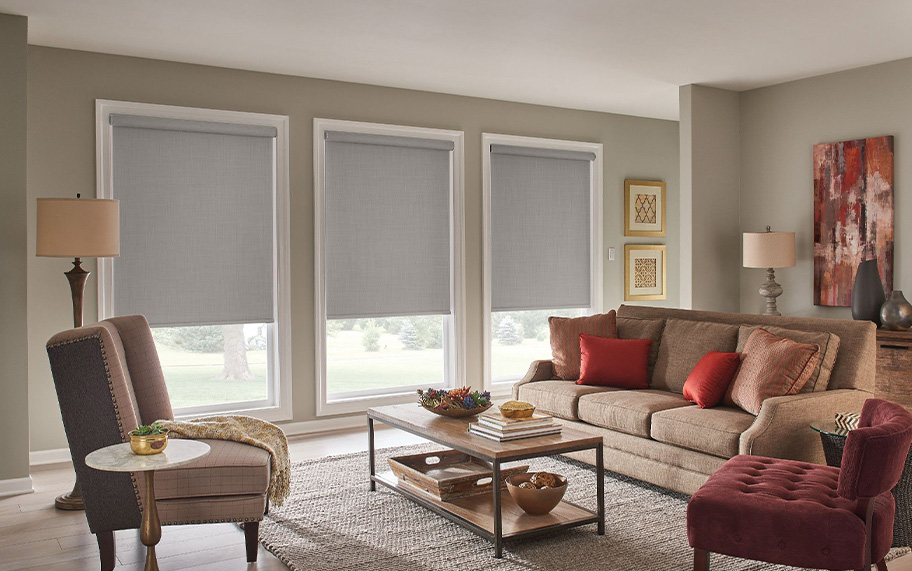 Our generous warranty means you'll enjoy your motorized shades for a long time. Light gray shades in a large living room