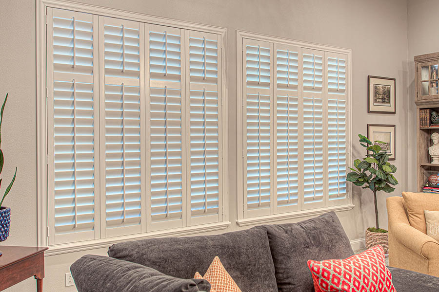 Polywood shutters are useful and beautiful for your home. White polywood shutters in a living room