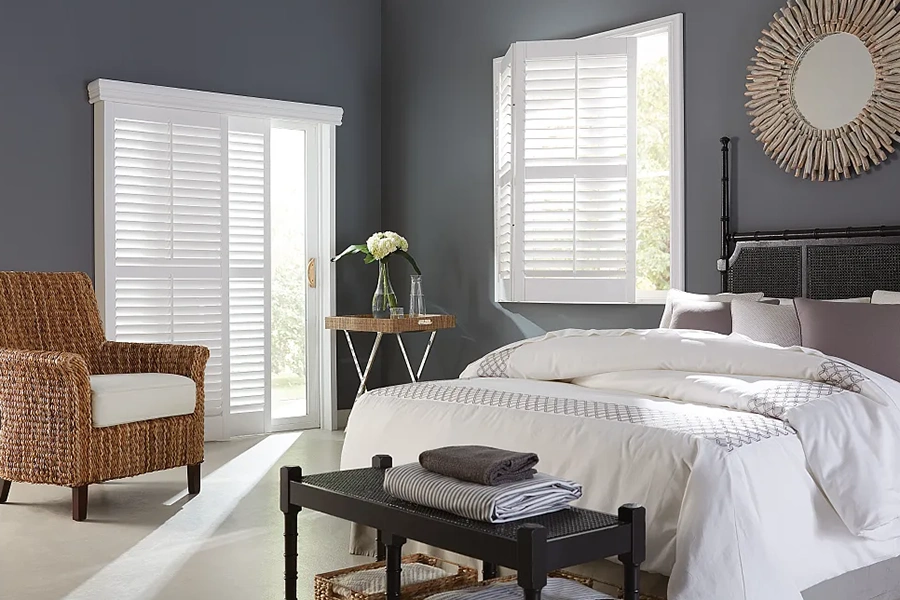 Opening shutter panels can give you an abundance of natural light. Open interior shutter letting light into a bedroom
