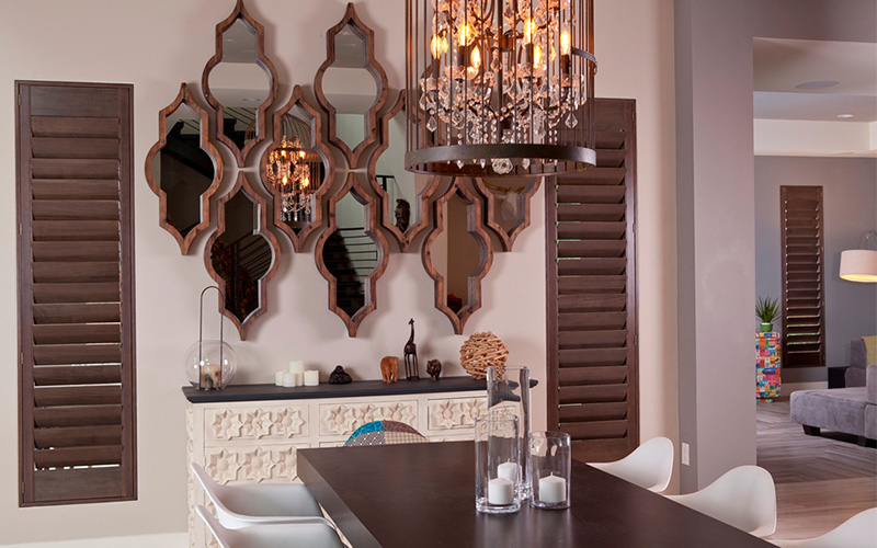 Dark brown ovation shutters in a beige and brown dining room.