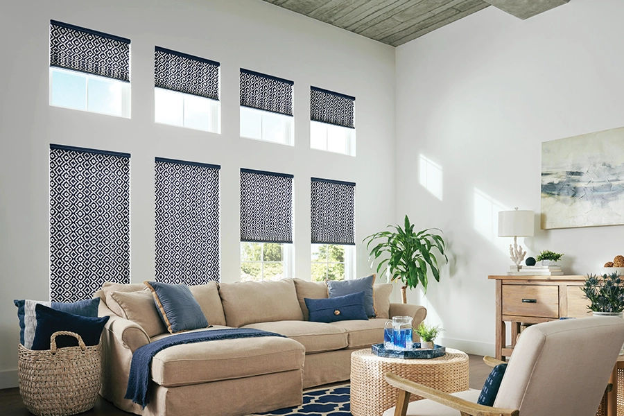 patterned cellular shades in blue and white patterns on tall and short windows in a living room
