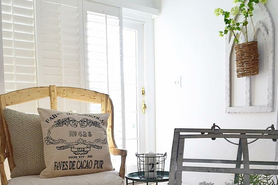 Design your relaxing space with natural hues, including white Polywood shutters. Polywood shutter slider in front of a patio door.