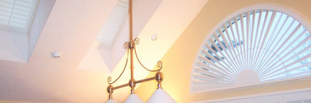 White polywood shutters in a recreational room. Skylights are shown on the ceiling.