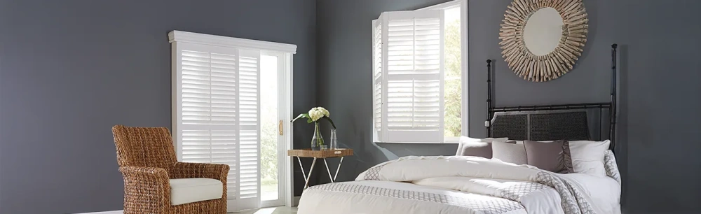 Sliding door shutters inside a large navy blue bedroom