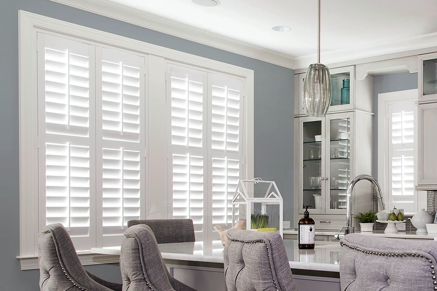 Polywood shutters last longer than windows. Use them to hide old windows and increase energy efficiency! White Polywood shutters on a large kitchen window